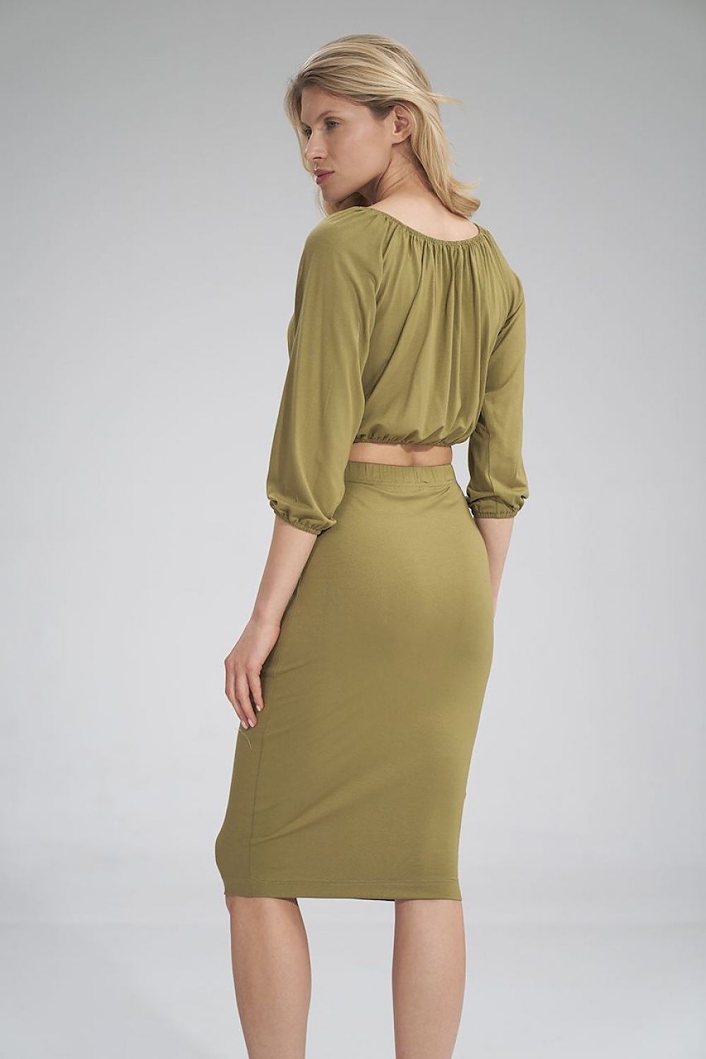 Chic back view of olive green blouse and skirt ensemble, highlighting the intricate details and luxurious fit by Figl.