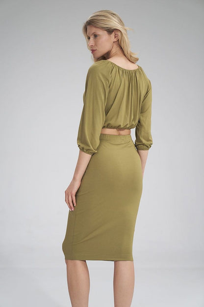 Chic back view of olive green blouse and skirt ensemble, highlighting the intricate details and luxurious fit by Figl.