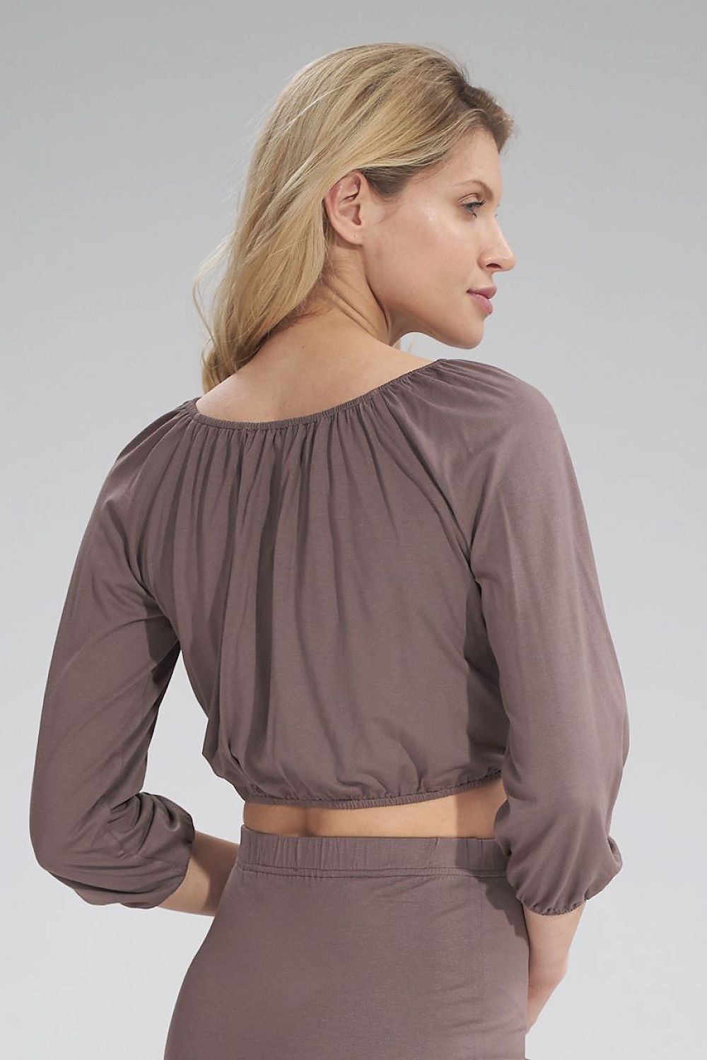 Close-up view highlighting the exquisite back design of the Figl 3/4 sleeve pleated blouse in taupe, elegantly designed with gathered detailing for an elevated look.