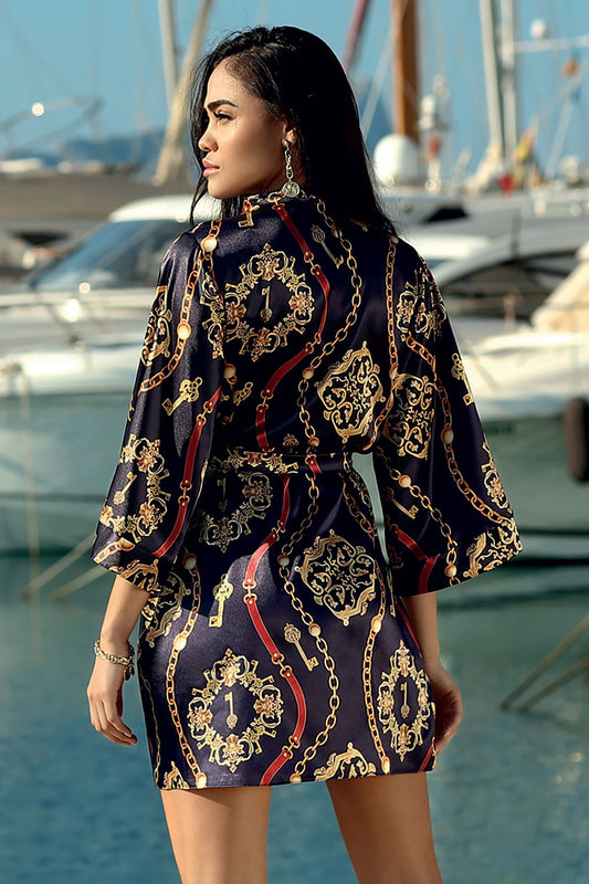 Luxury DKaren Satin Bathrobe with Expressive Pattern and 3/4 Sleeves - Mid-Thigh Length, featured from behind, revealing its exquisite pattern and sophisticated silhouette, set by a serene waterfront.