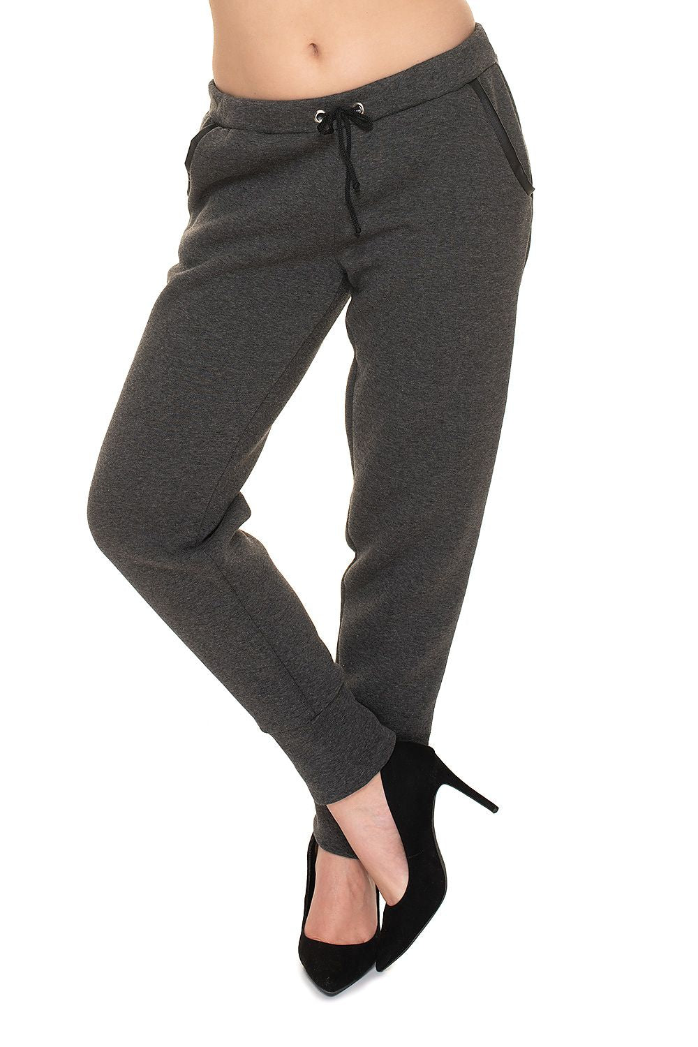 PeeKaBoo Luxe Loose-Fit Tracksuit Trousers featuring elegant eco-leather inserts, made from 95% cotton and 5% spandex, showcased with stylish heels.