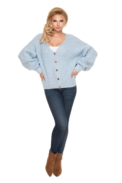 Chic front view of the PeeKaBoo Oversized Cardigan Sweater with Wooden Buttons, highlighting its voluminous sleeves and luxurious knit style, paired with stylish denim.