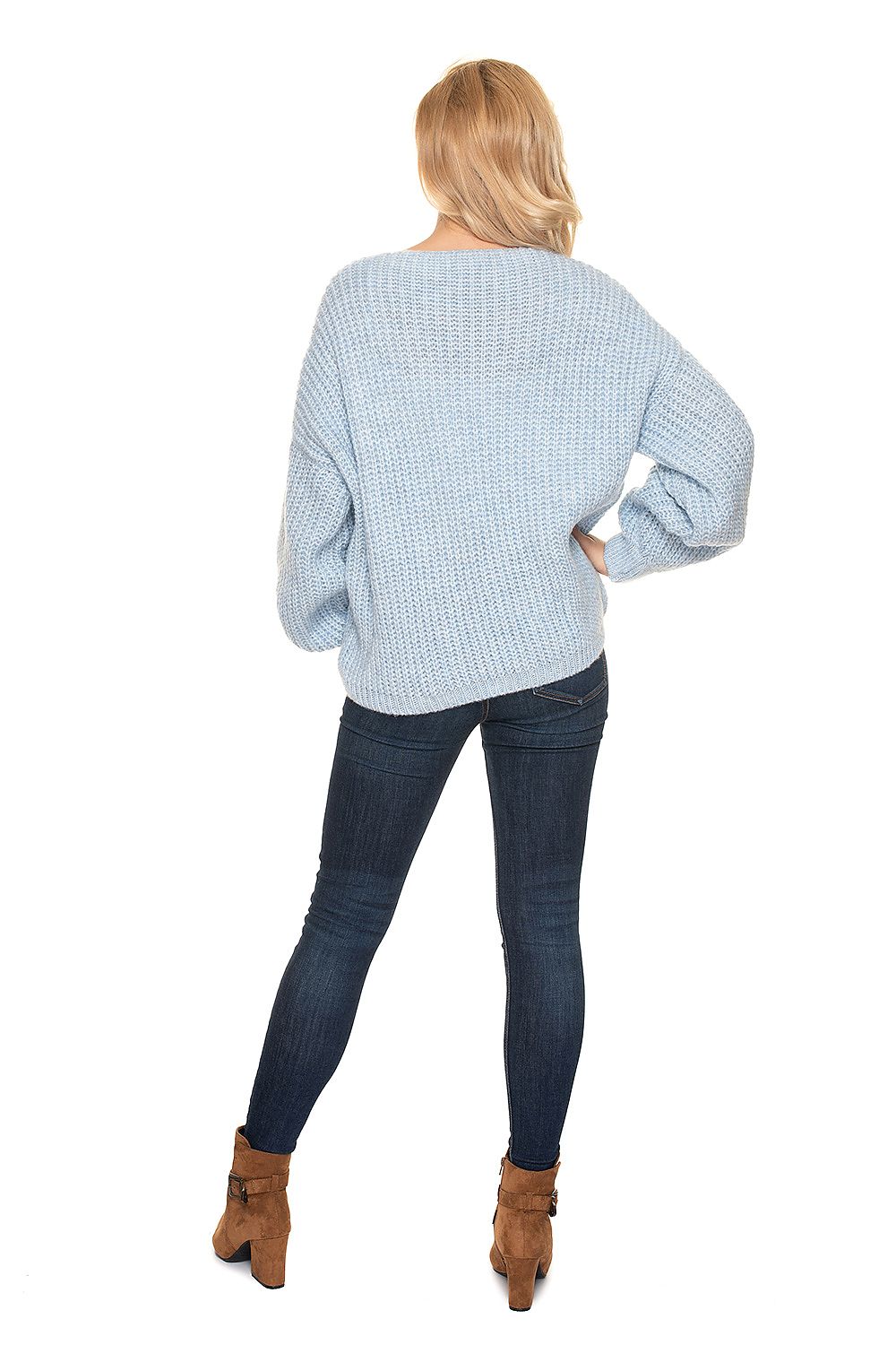 Fashionable back view of the PeeKaBoo Oversized Cardigan Sweater with Wooden Buttons, illustrating the elegant oversized silhouette, complemented by fitted jeans and ankle boots.