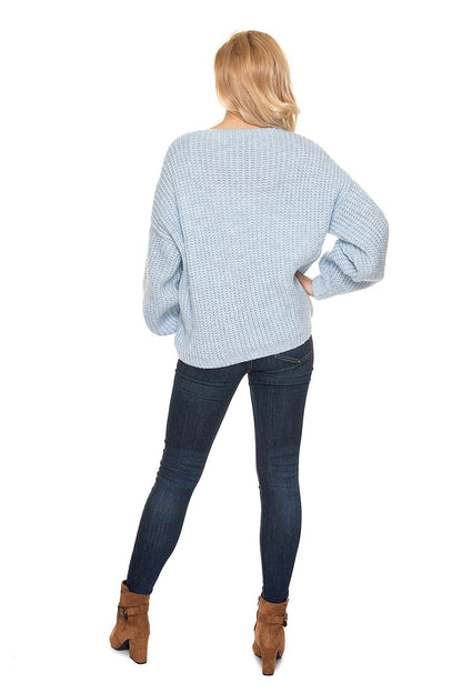 Fashionable back view of the PeeKaBoo Oversized Cardigan Sweater with Wooden Buttons, illustrating the elegant oversized silhouette, complemented by fitted jeans and ankle boots.