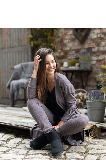 Luxury Brown Viscose Knitwear Cardigan with Pockets – Longer Style by Sensis, model lounging comfortably, smiling while wearing the cardigan paired with stylish lounge trousers.