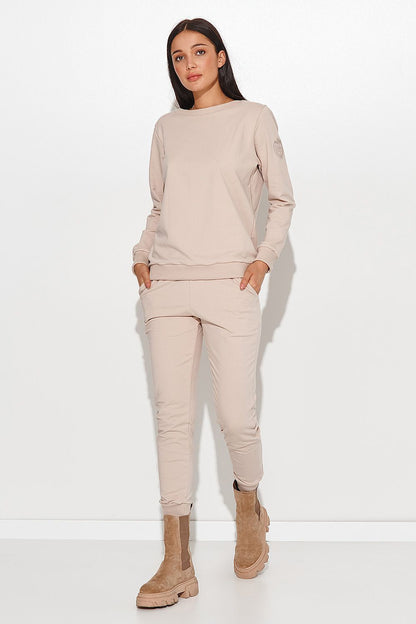 Elegant Numinou Two-Piece Cotton Knit Women's Set with Pocketed Pants - Model showcasing the stylish beige ensemble with comfort and sophistication.