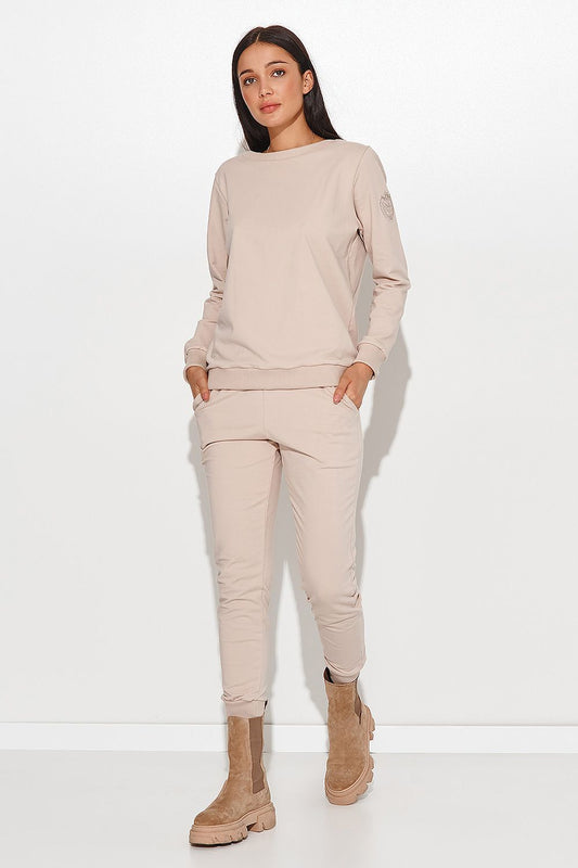 Elegant Numinou Two-Piece Cotton Knit Women's Set with Pocketed Pants - Model showcasing the stylish beige ensemble with comfort and sophistication.