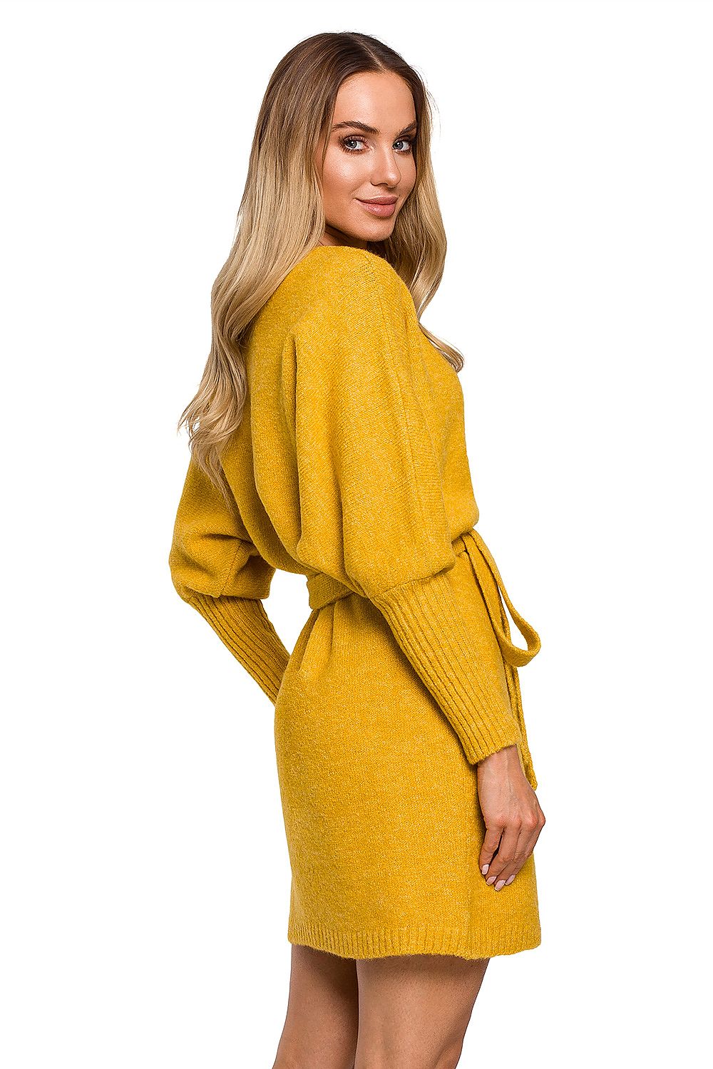 Sophisticated rear view of the model wearing the Elegant Moe Sweater Dress with Side Ties, Wide Sleeves, and Deep Overlap Neckline in striking mustard, illustrating the elegant fit and soft fabric.