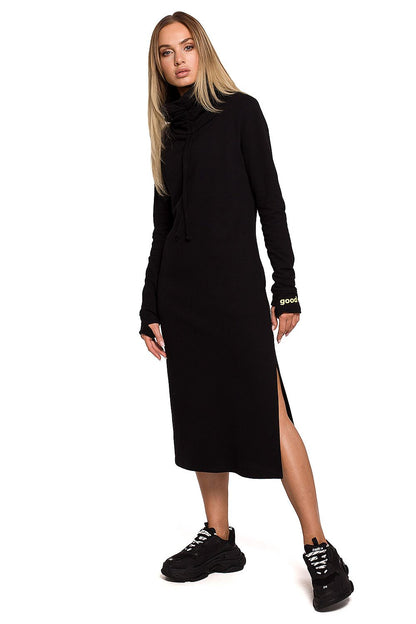 Luxury Knitted Maxi Dress with Side Slit, High Collar & Pockets by Moe in sleek black, showcasing a fashionable side slit and thumbhole cuffs.