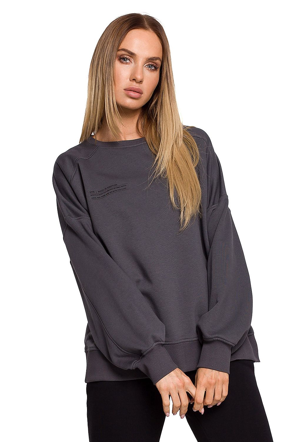 Elegant model showcasing a luxury oversized cotton sweatshirt with unique print, highlighting its moisture-resistant and soft touch features. Perfect for a stylish, comfortable look.