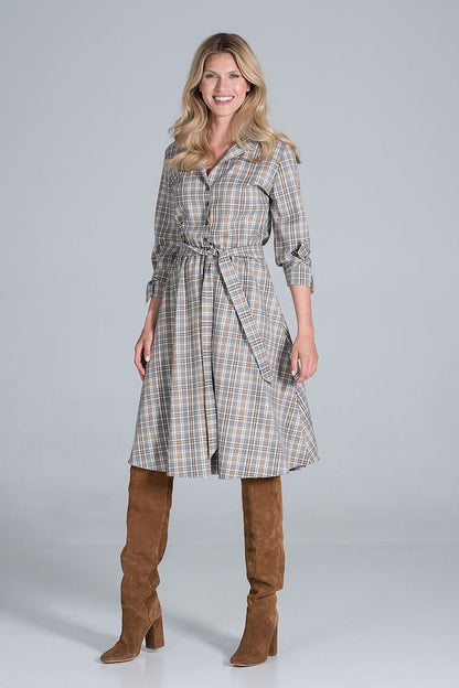 Front view of Elegant Midi Dress by Figl with jacket-style v-neck, showcasing a flared hem and stylish tie belt, complemented by sophisticated knee-high boots.