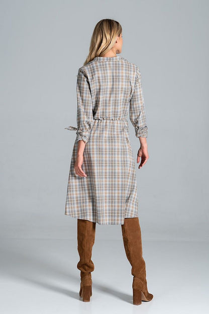 Back view of Elegant Midi Dress by Figl, highlighting its jacket-style v-neck and flared hem, styled with brown knee-high boots for an elegant finish.