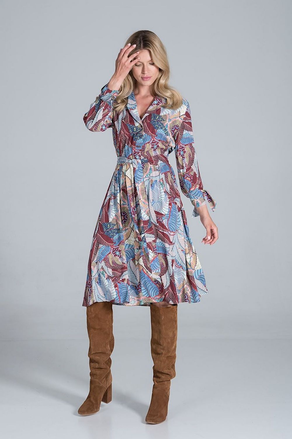 Elegant Midi Dress by Figl with Jacket-Style V-Neck, Flared Hem & Tie Belt, showcased in an eye-catching colourful design, worn by a model styled with knee-high brown boots.