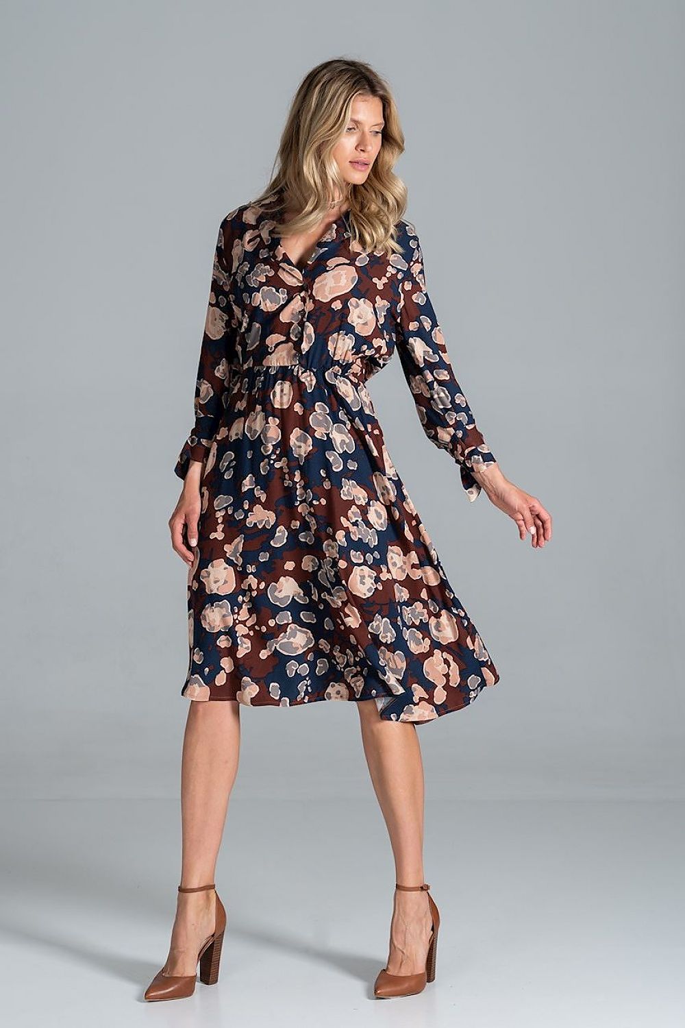 Elegant Midi Dress by Figl, featuring a floral pattern, jacket-style v-neck, and flared hem, model displayed gracefully with chic high-heeled shoes.