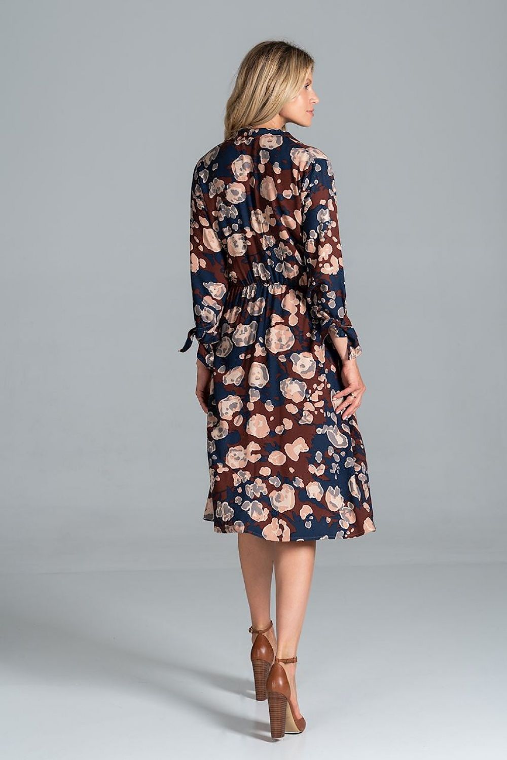 Elegant Midi Dress by Figl with Jacket-Style V-Neck, Flared Hem & Tie Belt, featuring a stunning floral pattern on a navy background, highlighted from the back with a flared hem and cinched waist for a chic and sophisticated look.