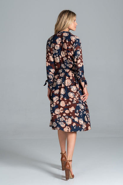 Elegant Midi Dress by Figl with Jacket-Style V-Neck, Flared Hem & Tie Belt, featuring a stunning floral pattern on a navy background, highlighted from the back with a flared hem and cinched waist for a chic and sophisticated look.