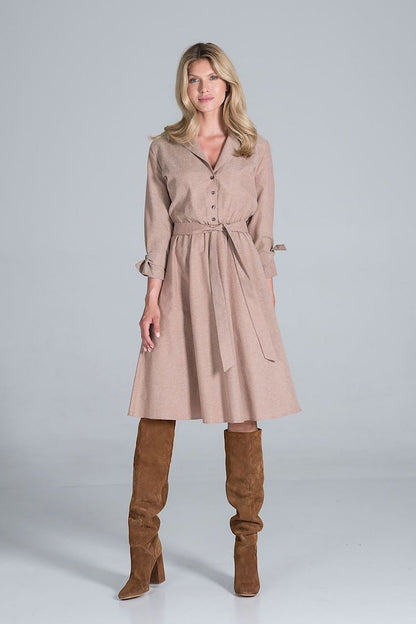 Elegant Midi Dress by Figl presented with a sophisticated jacket-style v-neck, flared hem, and stylish tie belt, complemented by fashionable knee-high boots.