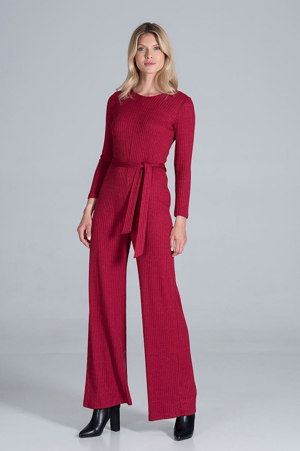 Elegant Figl Wide-Legged Jumpsuit with Back Slit in Flowing Ribbed Knit, showcasing a model wearing the rich burgundy design with a belted waist and long sleeves, exuding luxury and sophistication.
