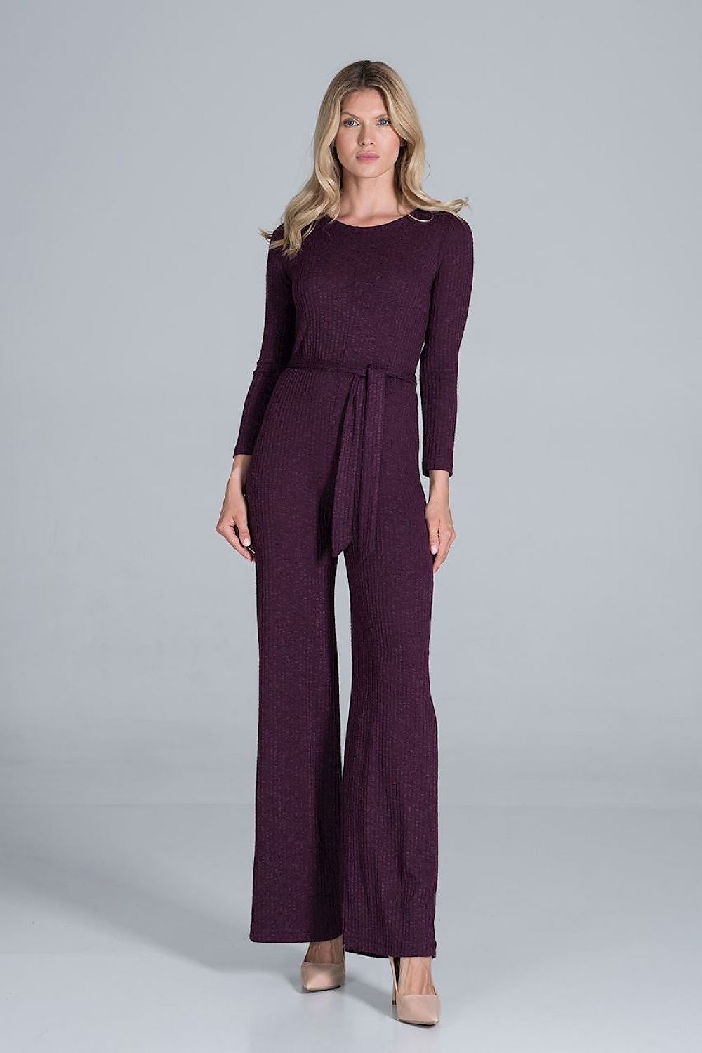 Elegant Figl Wide-Legged Jumpsuit with Back Slit in Flowing Ribbed Knit, model poses elegantly in rich plum colour, accentuating the luxurious fabric and fit.