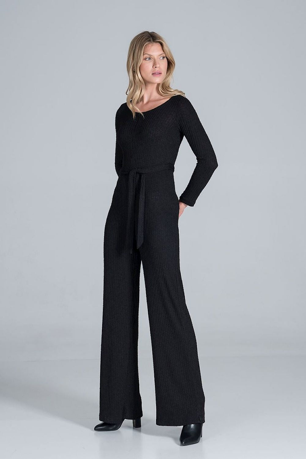 Elegant Figl Wide-Legged Jumpsuit with Back Slit in Flowing Ribbed Knit, captured in black, with a long-sleeve silhouette and elegant waist tie, exuding a sense of refined luxury.