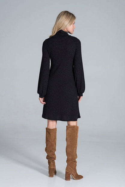 Back view of the Elegant Turtleneck Midi Dress in Flowing Ribbed Knit by Figl, featuring long sleeves and a refined cut, complemented by tall suede boots for a chic appearance.
