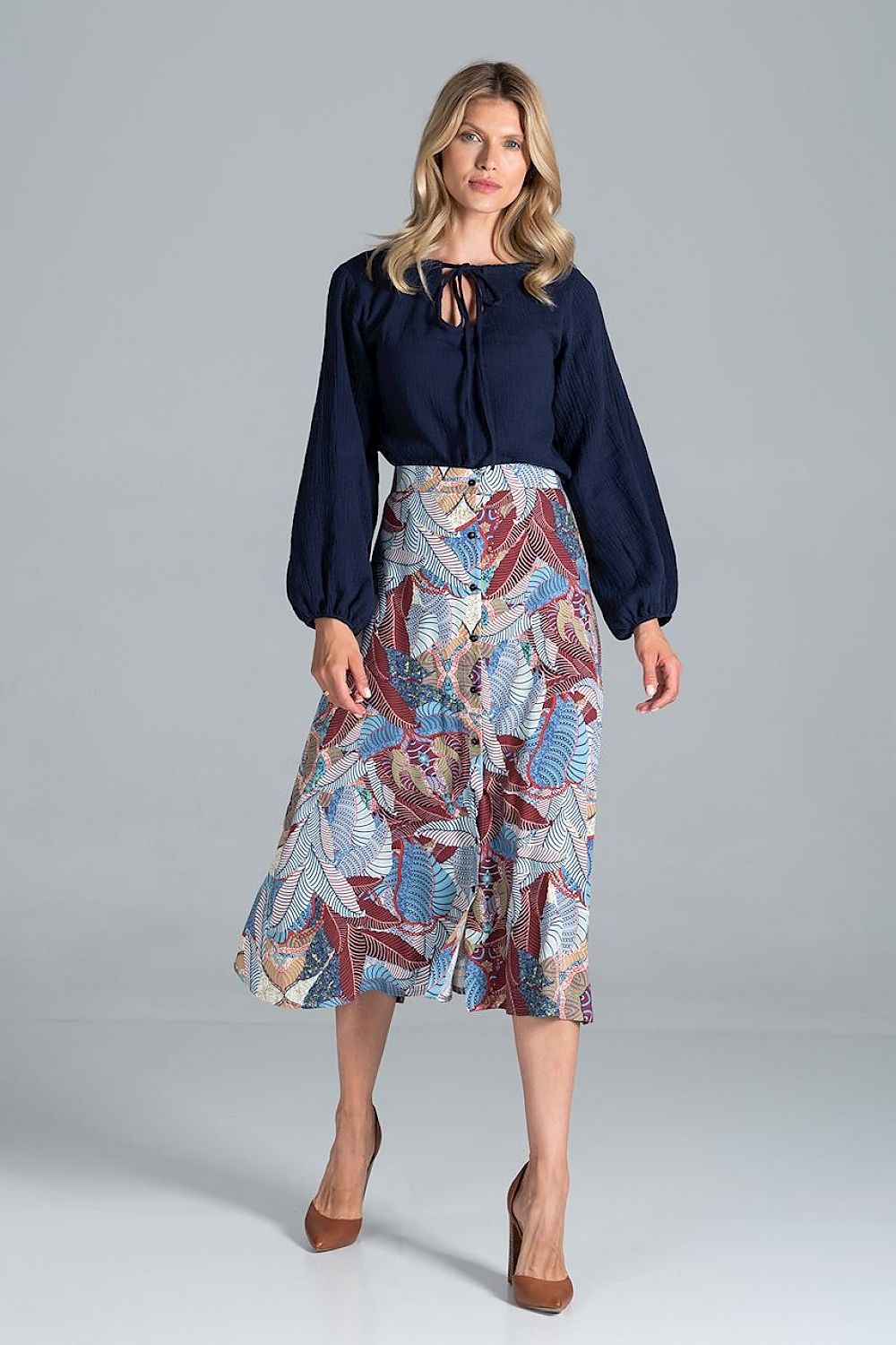 Elegant Figl Trapeze Midi Skirt With Front Buttons showcased with a chic navy blouse, highlighting the vibrant floral design in hues of blue and red, perfect for sophisticated occasions.