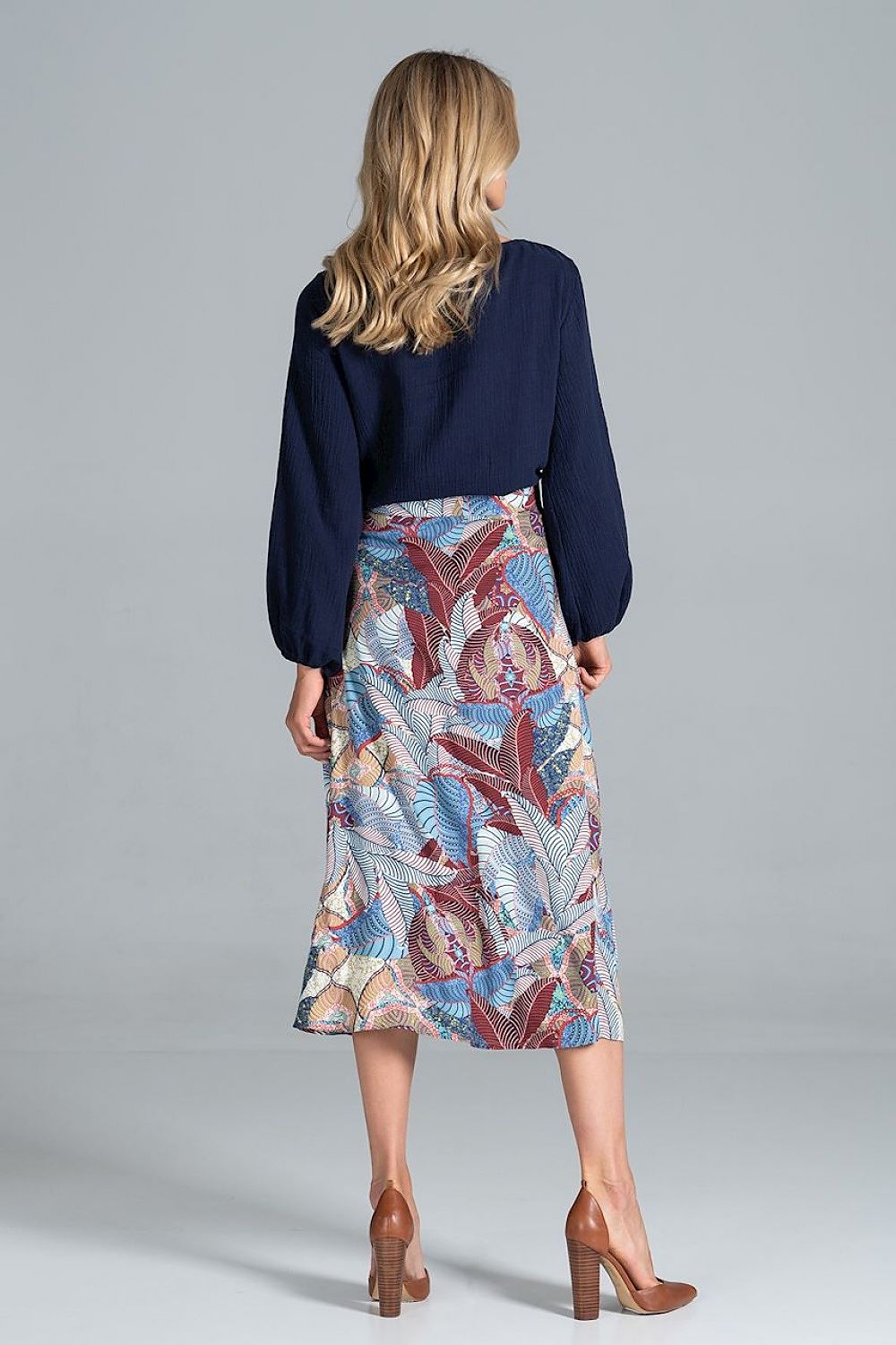 Back view of the Figl Trapeze Midi Skirt With Front Buttons paired with a navy blouse, focusing on the luxurious fabric and intricate floral patterns, ideal for stylish ensembles.