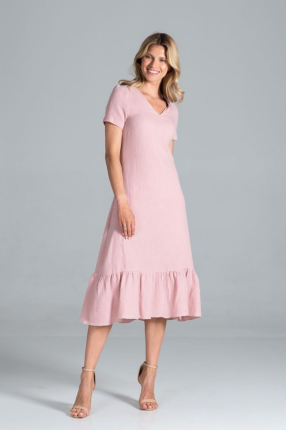 Side view of the Elegant Midi Dress with Sweetheart Neckline and Flouncy Hem by Figl in light pink, illustrating its elegant shape and comfortable fit.