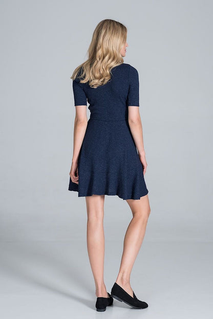 Elegant Figl Mini Daydress in Flowy Ribbed Knit with flounce hem, captured from the back, emphasising the elegant silhouette of the dress.