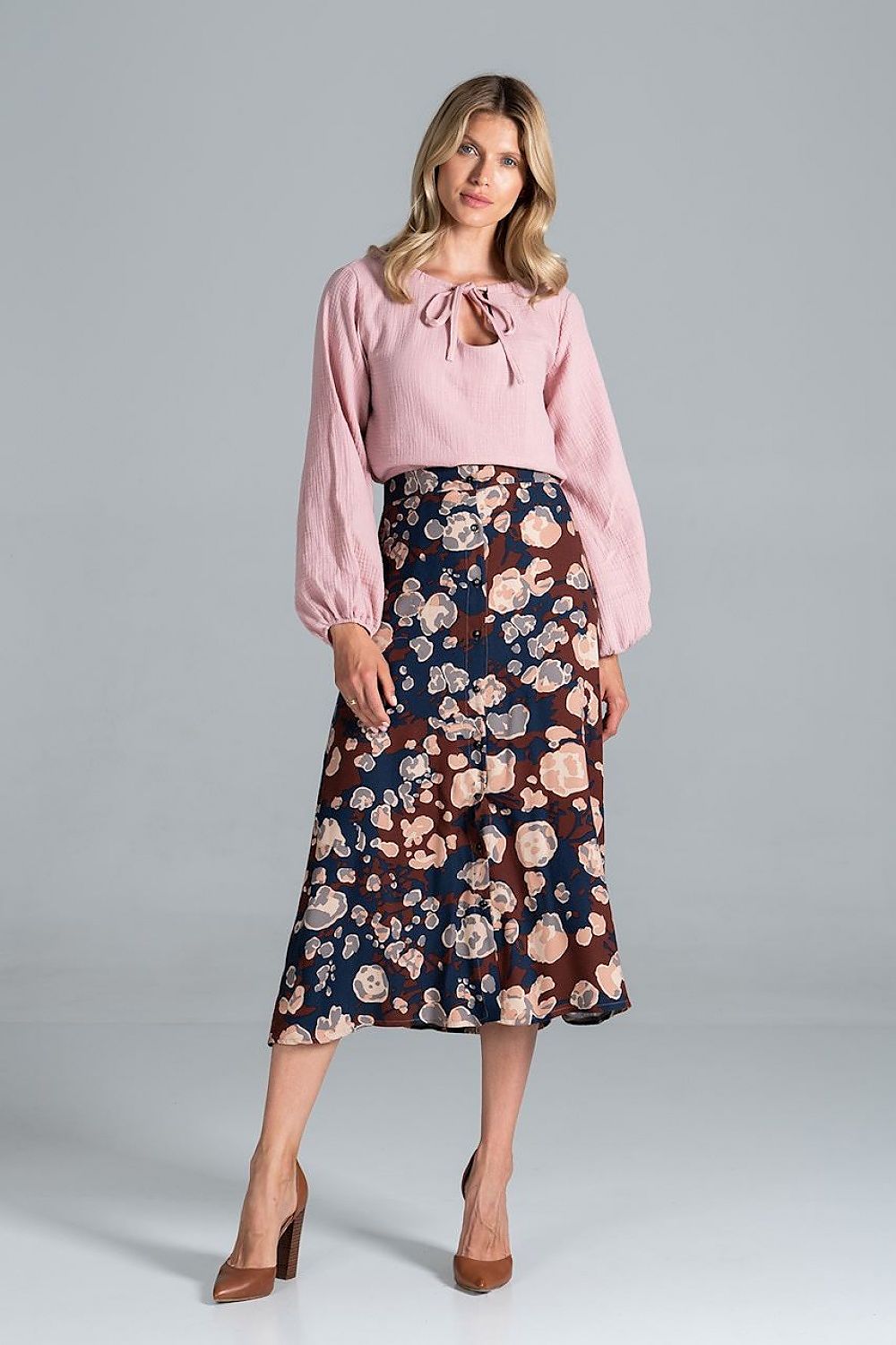 Luxury Figl Blouse featuring a half-round neckline with a tied string and long sleeves, paired with a floral patterned skirt, showcasing a sophisticated look.