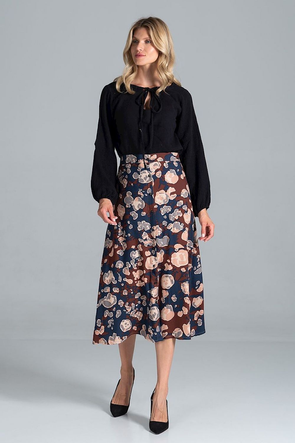 Chic front view of a Luxury Figl Blouse with Half-Round Neckline, Long Sleeves & Elastic Band, 100% Viscose, elegantly paired with a floral skirt for a refined look.