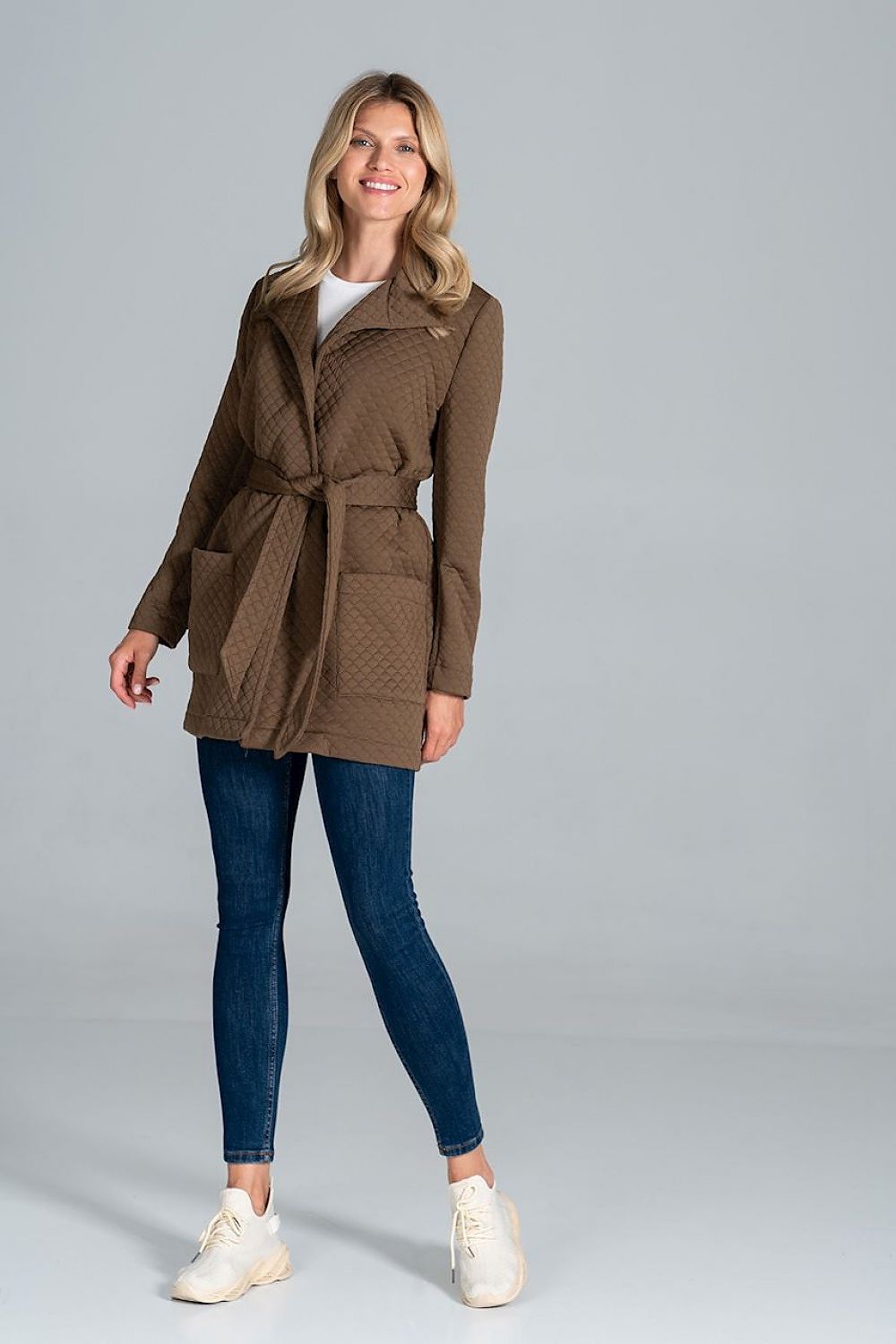 A model showcasing the Figl Short Quilted Coat With Belt And Collar, featuring an unlined design with front patch pockets, perfect for a luxury style.