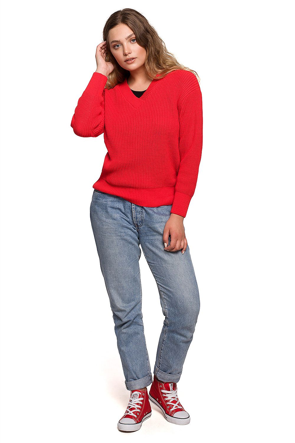 Luxurious Oversize V Neck Acrylic Knit Jumper for Women worn stylishly with denim jeans and red sneakers, showcasing an autumn outfit essential.
