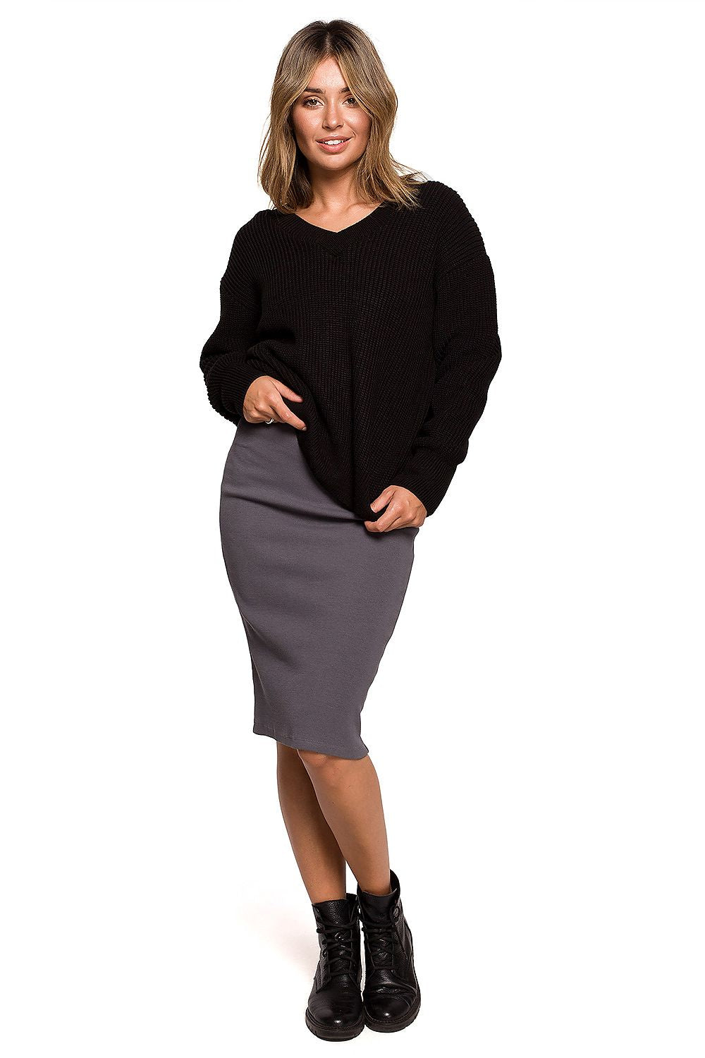 Luxurious Oversize V Neck Acrylic Knit Jumper for Women styled with a sleek grey skirt, giving a sophisticated look ideal for autumn.
