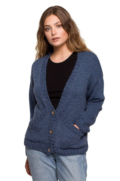 Model wearing the Elegant BE Knit Short Cardigan with Button Front and Pockets in deep blue, an elegant addition to autumn outfits, paired with a casual black top.