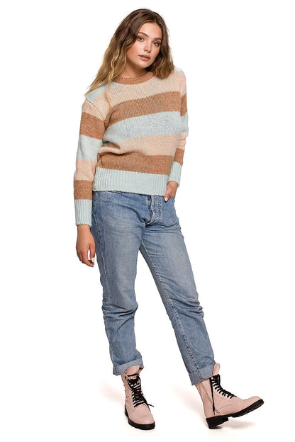 Luxurious BE Knit Jumper showcased with stylish striped pastel hues, effortlessly styled with denim jeans, ideal for autumn and winter fashion.