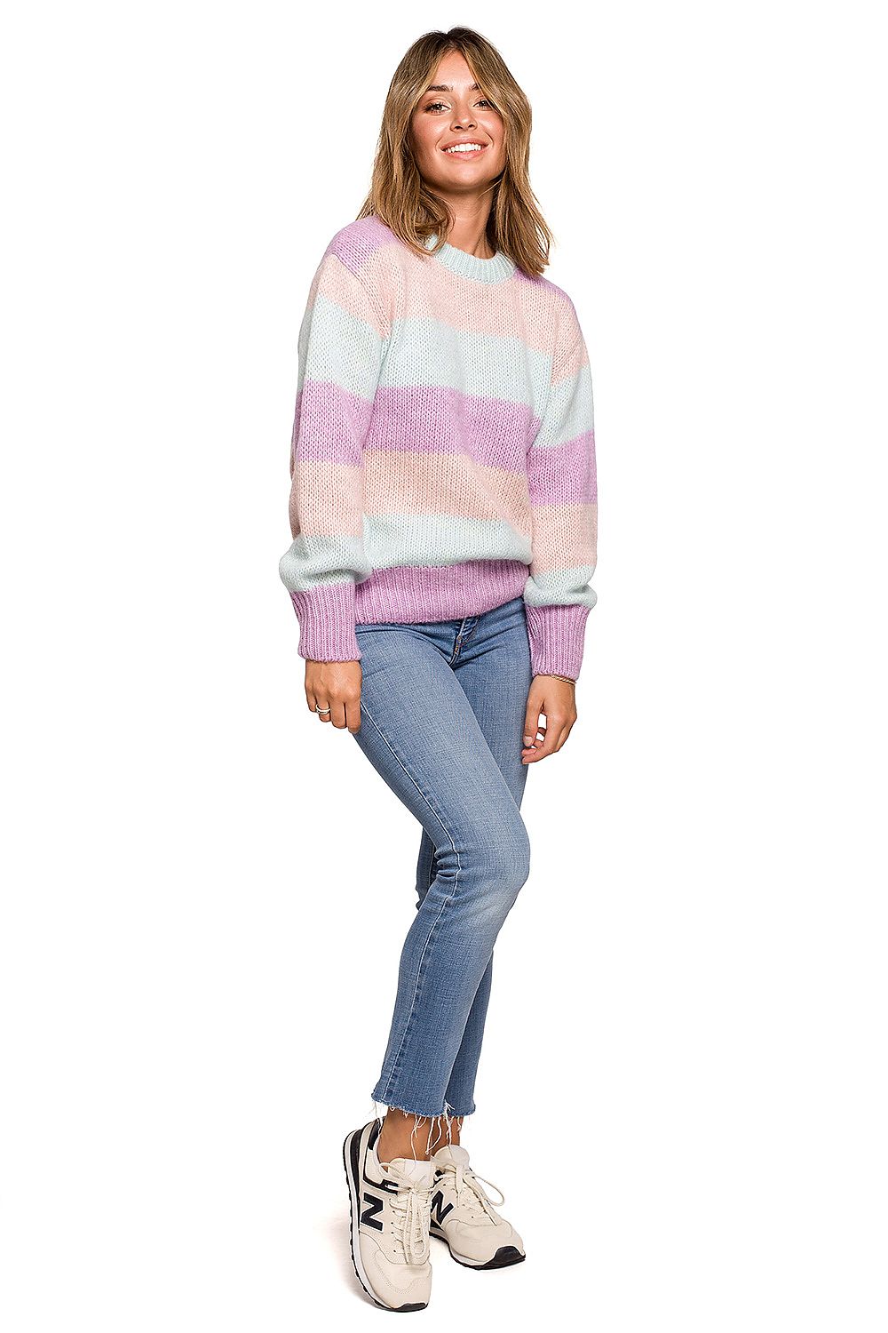 Happy model wearing the Luxurious BE Knit Jumper in elegant pastel stripes, paired with denim, perfect for a stylish autumn or winter day.