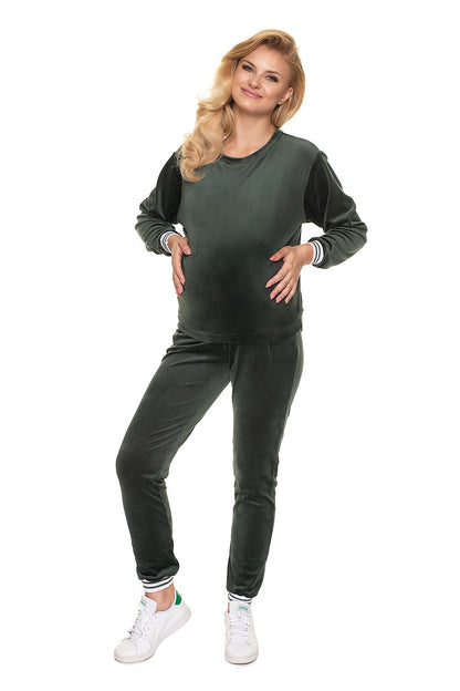 Luxurious PeeKaBoo Velour Tracksuit Set in a rich green hue, featured on a smiling pregnant model, highlighting the soft velour fabric.