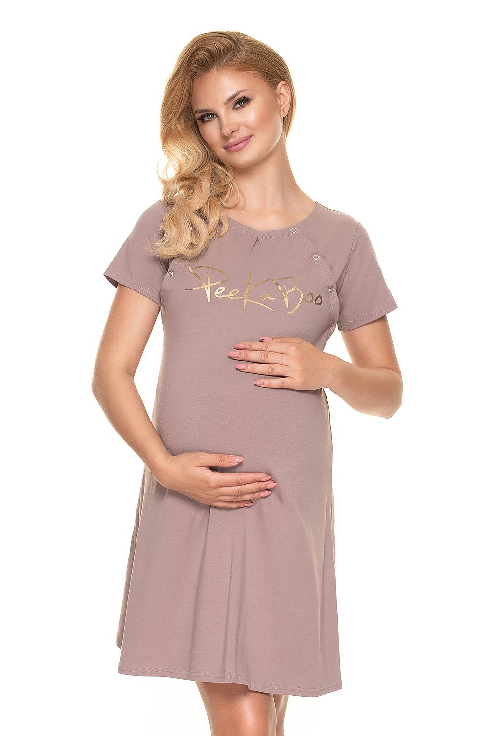 Pregnant model smiling while wearing the Luxury Maternity Nightshirt by PeeKaBoo in a soft colour, featuring the prestigious gold logo.