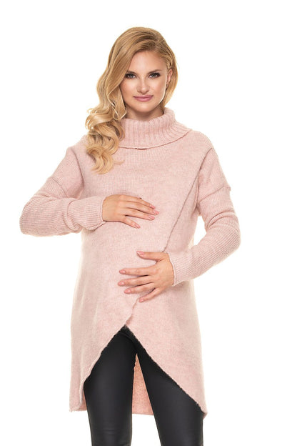 Luxurious Wool Blend Pregnancy Sweater with Turtleneck - PeeKaBoo Asymmetrical Design, featuring a model in a beautiful pink variant, radiating elegance while gently holding her pregnant belly.
