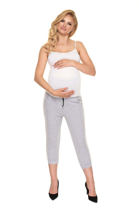 PeeKaBoo Elegant Fit Ribbed Cotton Maternity Crop Pants with Side Pockets showcased by a beautiful pregnant model wearing a white tank top, smiling gracefully, perfect for stylish motherhood.