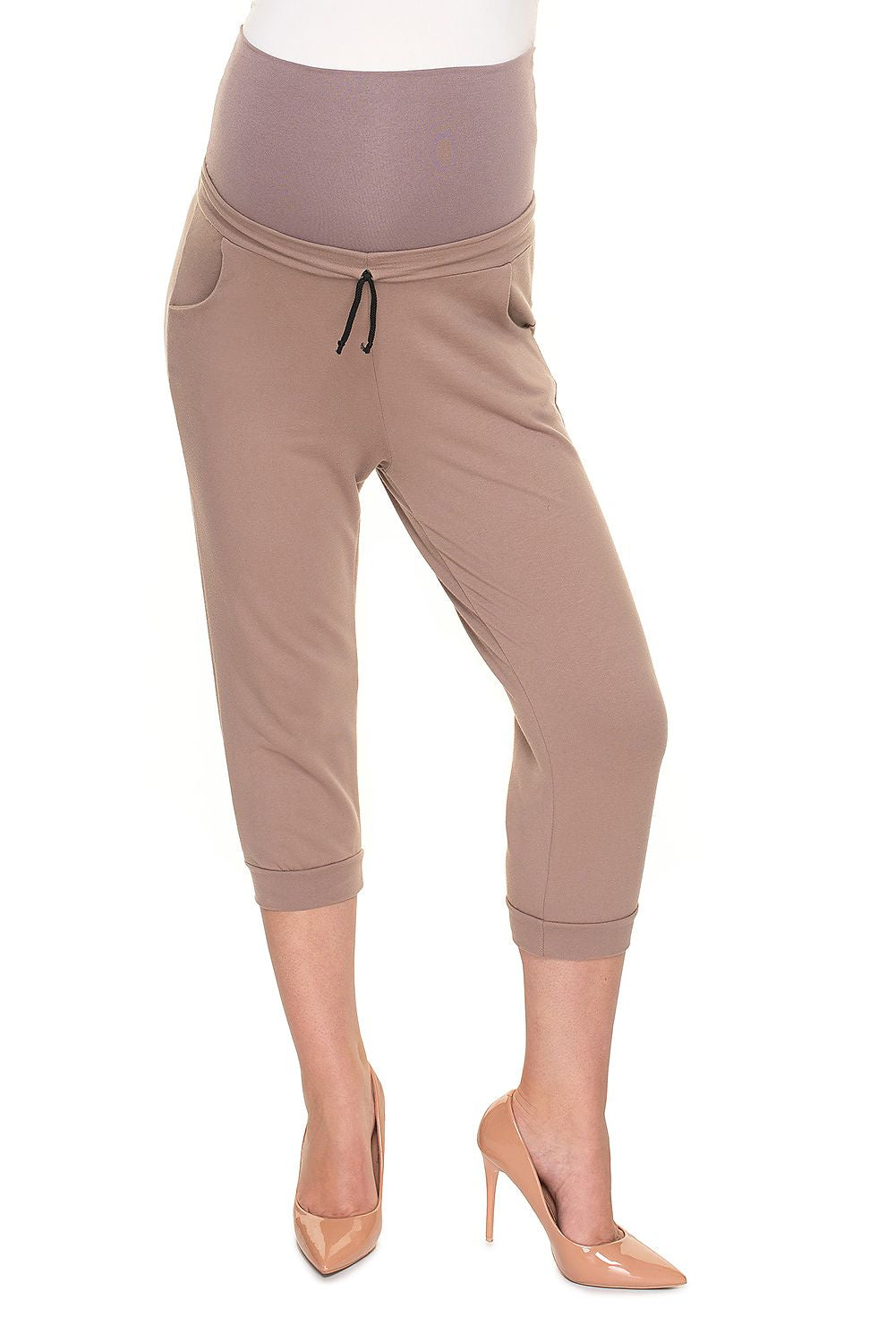 Chic pregnant model in light brown PeeKaBoo Elegant Fit Ribbed Cotton Maternity Crop Pants with Side Pockets, confidently displaying comfort and style.