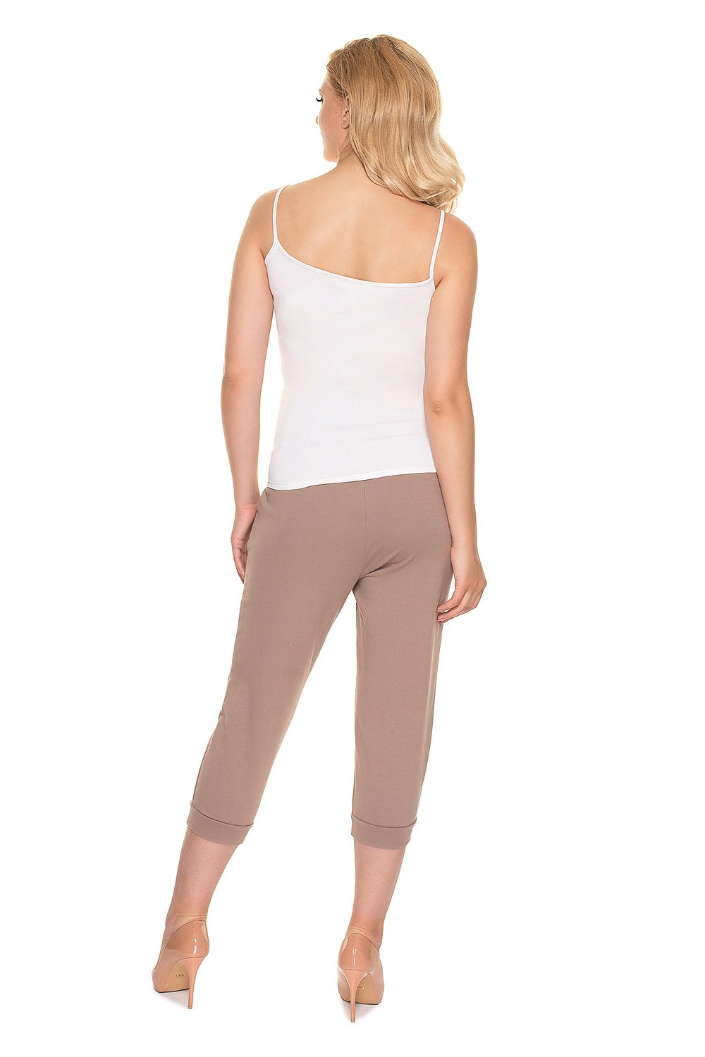Back view of a chic pregnant model showcasing the light brown PeeKaBoo Elegant Fit Ribbed Cotton Maternity Crop Pants with Side Pockets, paired effortlessly with a white tank top.
