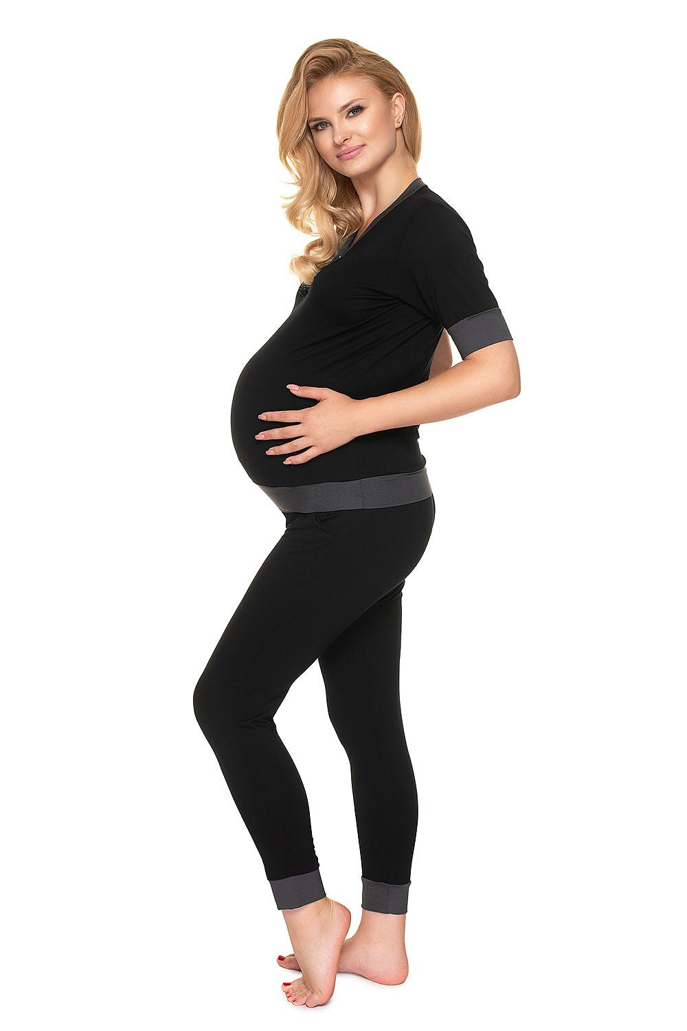 Luxury Maternity & Nursing Pajamas with Fasteners for Effortless Breastfeeding - PeeKaBoo, model displaying a side profile in black nursing set, accentuating the comfort and elegance.