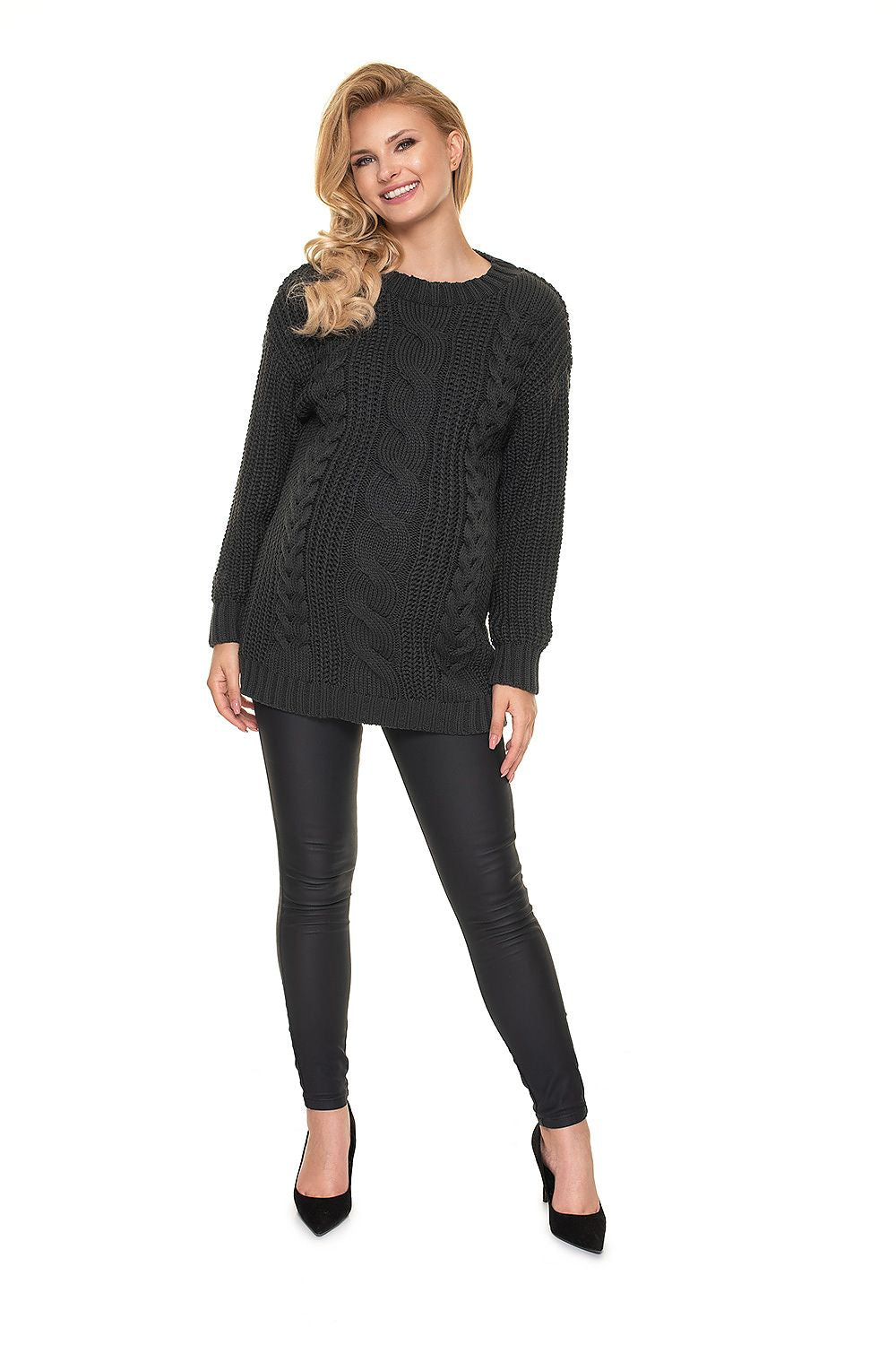 Elegant Pregnancy Sweater by PeeKaBoo - presenting a front view of a radiant pregnant woman in a chic soft acrylic pullover with intricate braided detailing, paired with fitted black leggings and elegant heels.
