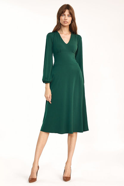 Elegant Classic Midi Dress with V Neckline and Long Sleeves by Nife, showcased on a model in a rich green colour, perfect for both work and casual wear.