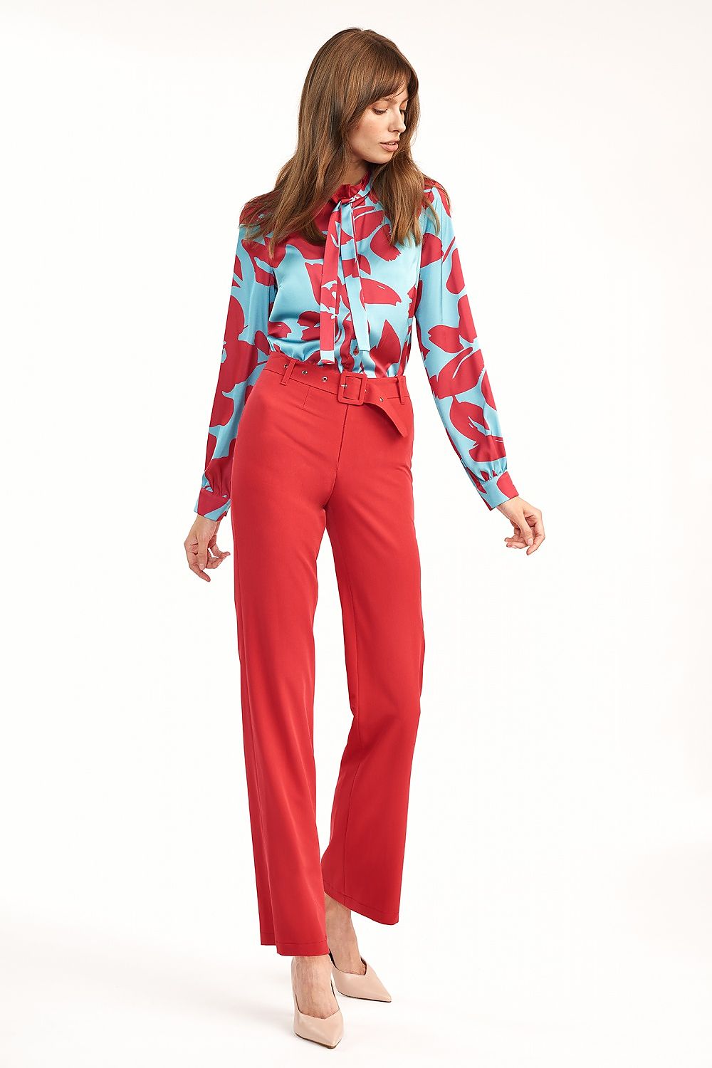 Elegant Nife Long Sleeve Blouse with Font Pattern on a model, styled with red trousers, highlighting the luxurious fabric and bold colour contrast for a contemporary fashion statement.
