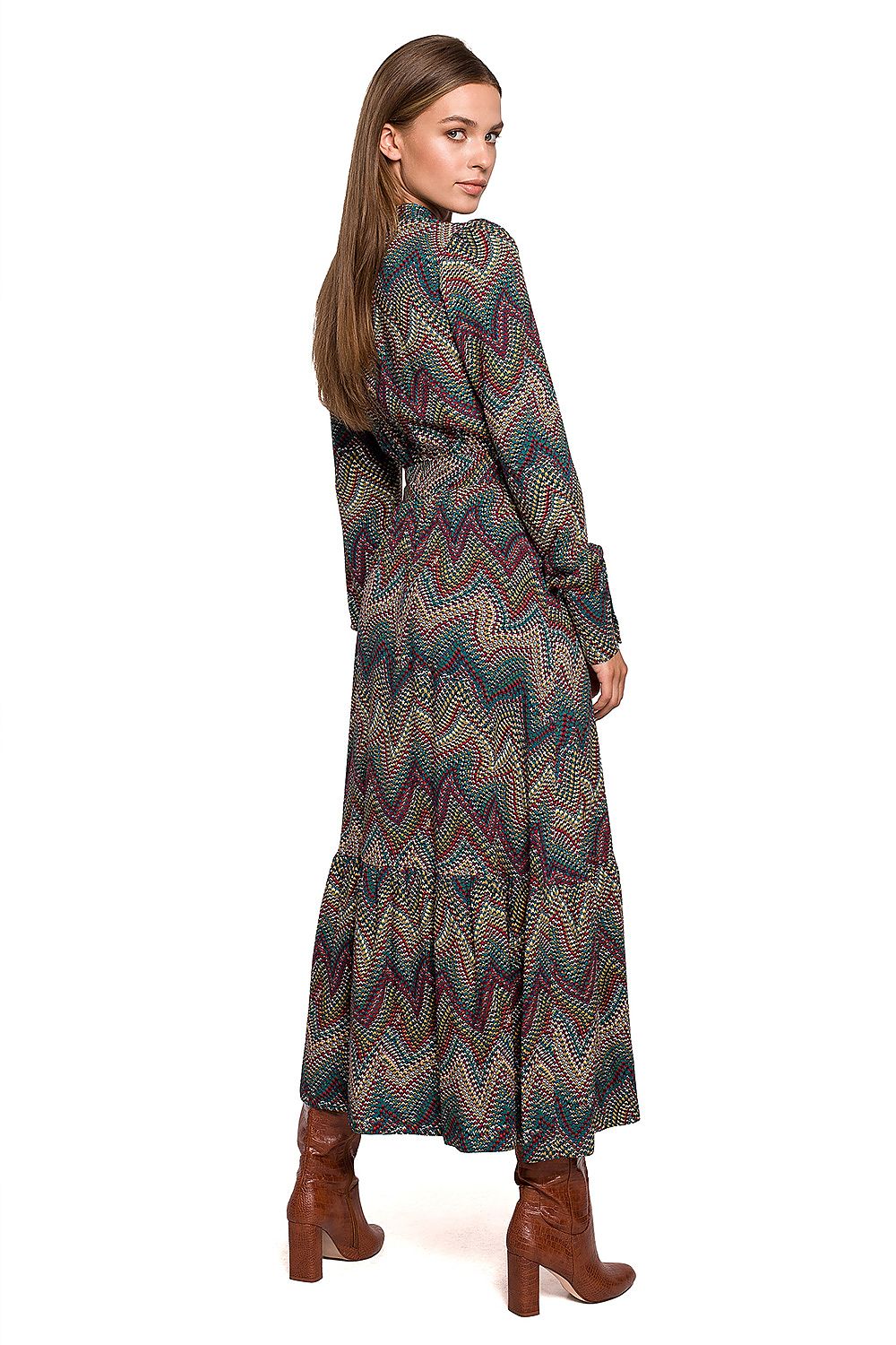 Stylove Aztec Pattern Daydress displaying a ruffle hem and stand-up collar from the back, perfect for elegant autumn styling. Model paired with fashionable ankle boots.