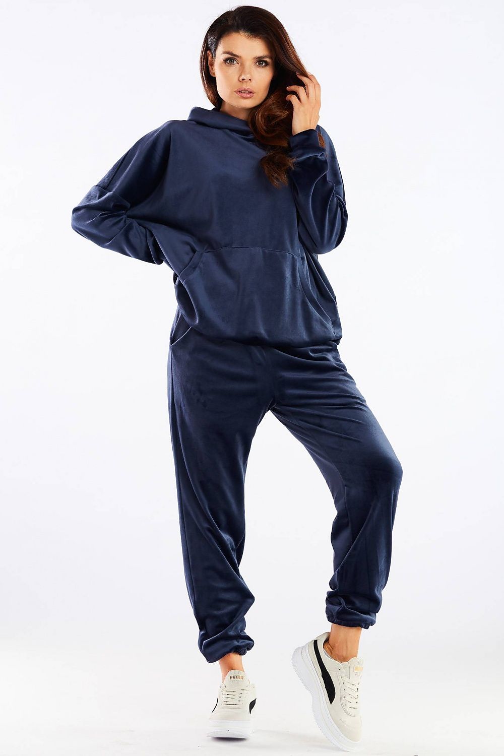 Luxury Awama Velour Tracksuit Trousers in navy, featuring a loose fit design, made of soft velour fabric, showcased on a model during a stylish pose. Perfect for casual elegance and comfort.
