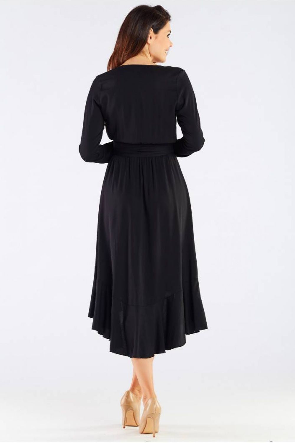 Rear view of the Elegant Awama Ladies Cocktail Dress with Envelope Neckline and Frill Detail in Natural Viscose. The model wears the dress highlighting its elegant cut and frilled hem, designed for a graceful appearance.